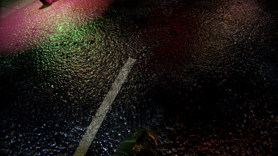 Wet asphalt at night, neon broken up in its grit and puddles
